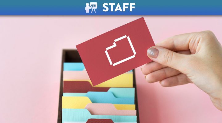 Handing holding a card with an abstract icon with folders in the background