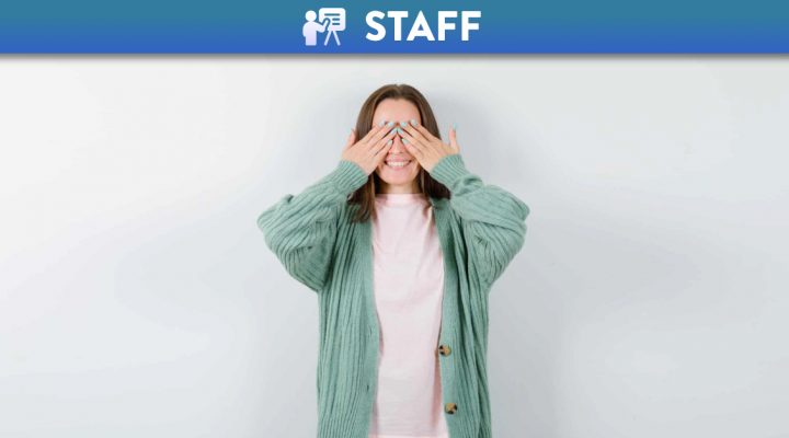 Expressive young woman posing and covering her eyes