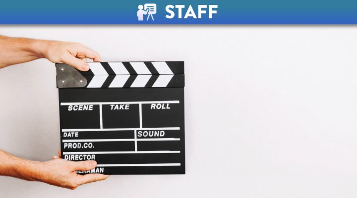 Hands holding a movie clapper board