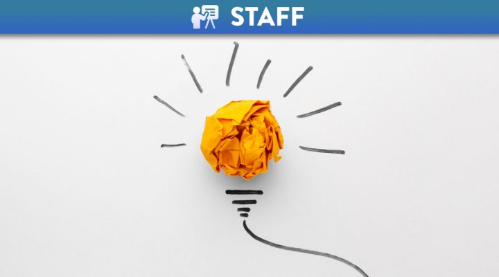 Scrumpled up ball of yellow paper with lines to represent a light bulb