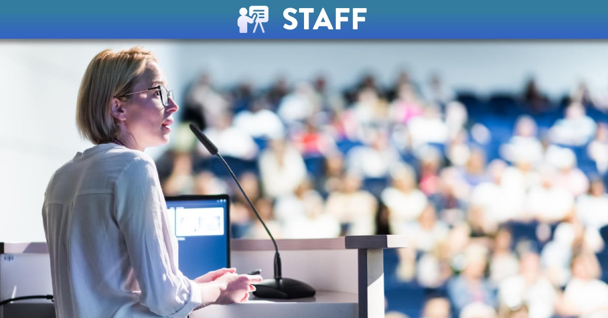 Female academic teaching class in lecture theatre
